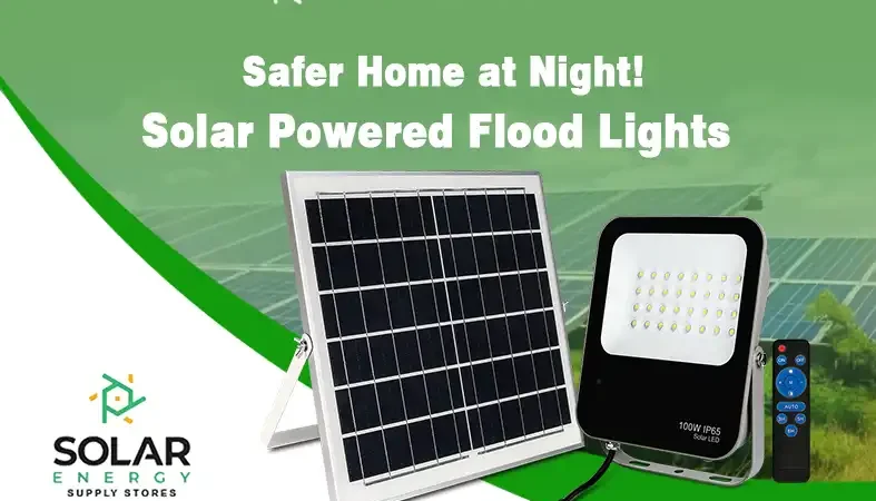 Solar-powered flood lights mounted on a wall illuminating a compound at night