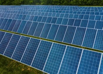 Rows of blue solar panels lined up at a photovoltaic power station