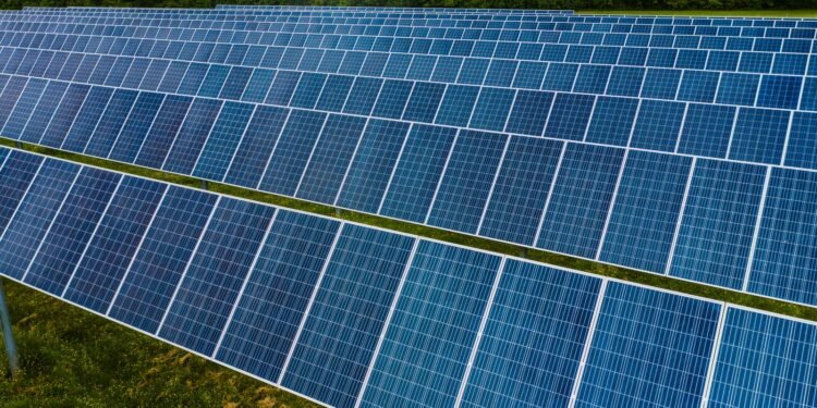 Rows of blue solar panels lined up at a photovoltaic power station