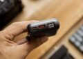 Close-up of a portable power bank with a lit digital display