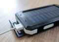 Black solar power bank with charging cable, a small way to store solar energy