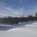 Solar panels standing in a snowy field in winter under a clear sky