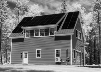 House with a roof covered in solar panels, viewed from outside