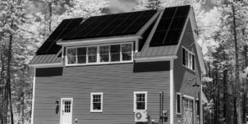 House with a roof covered in solar panels, viewed from outside