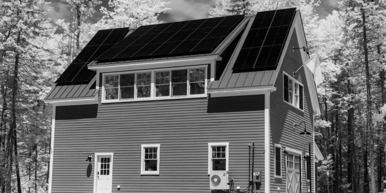 House with a roof covered in solar panels, viewed from outside