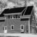House with a roof covered in solar panels, viewed from outside