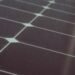 Close-up of photovoltaic cells and silver busbars that make up a solar panel