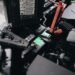 Car battery mounted beside an engine under an open hood
