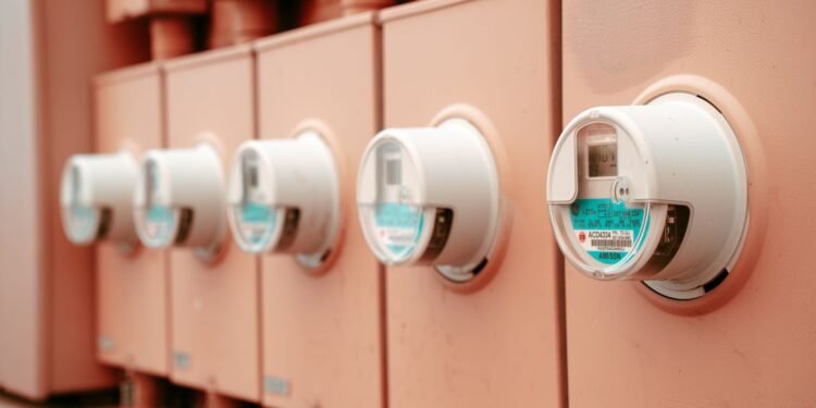 Close-up of a row of electricity meters mounted side by side on a wall