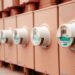 Close-up of a row of electricity meters mounted side by side on a wall