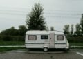 Camper trailer parked on its own in an outdoor setting