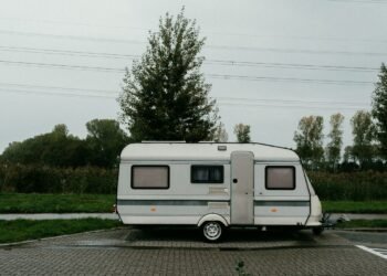 Camper trailer parked on its own in an outdoor setting