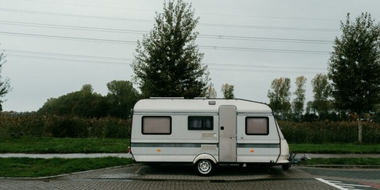 Camper trailer parked on its own in an outdoor setting