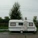 Camper trailer parked on its own in an outdoor setting