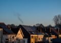 Row of suburban houses with solar panels installed on their roofs