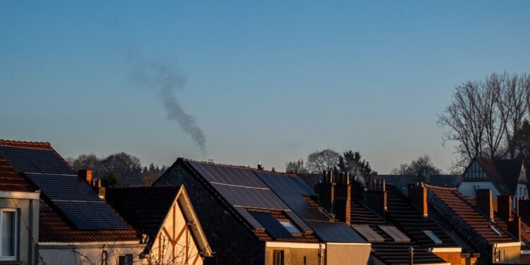 Row of suburban houses with solar panels installed on their roofs