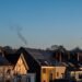 Row of suburban houses with solar panels installed on their roofs