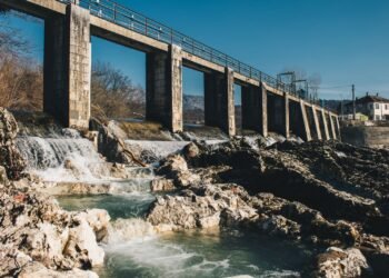 Concrete hydroelectric dam holding back a large reservoir of water