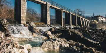 Concrete hydroelectric dam holding back a large reservoir of water