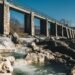 Concrete hydroelectric dam holding back a large reservoir of water