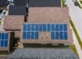 Rows of solar panels installed on the tiled roof of a house