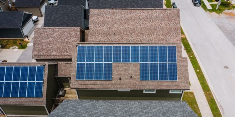 Rows of solar panels installed on the tiled roof of a house