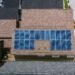 Rows of solar panels installed on the tiled roof of a house